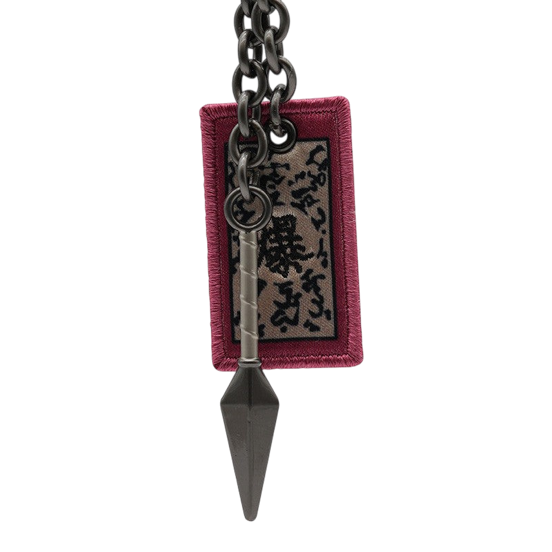 Porte-clés NIPPON DOKI STORE Naruto 3D représentant un kunaï en métal gris et un parchemin explosif en tissu rouge