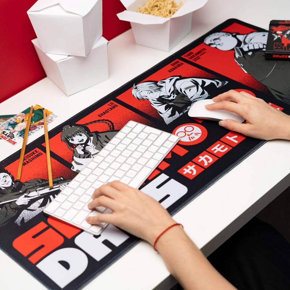 NIPPON DOKI STORE Sakamoto Days XL desk mat featuring manga characters on a red and black background on a desk